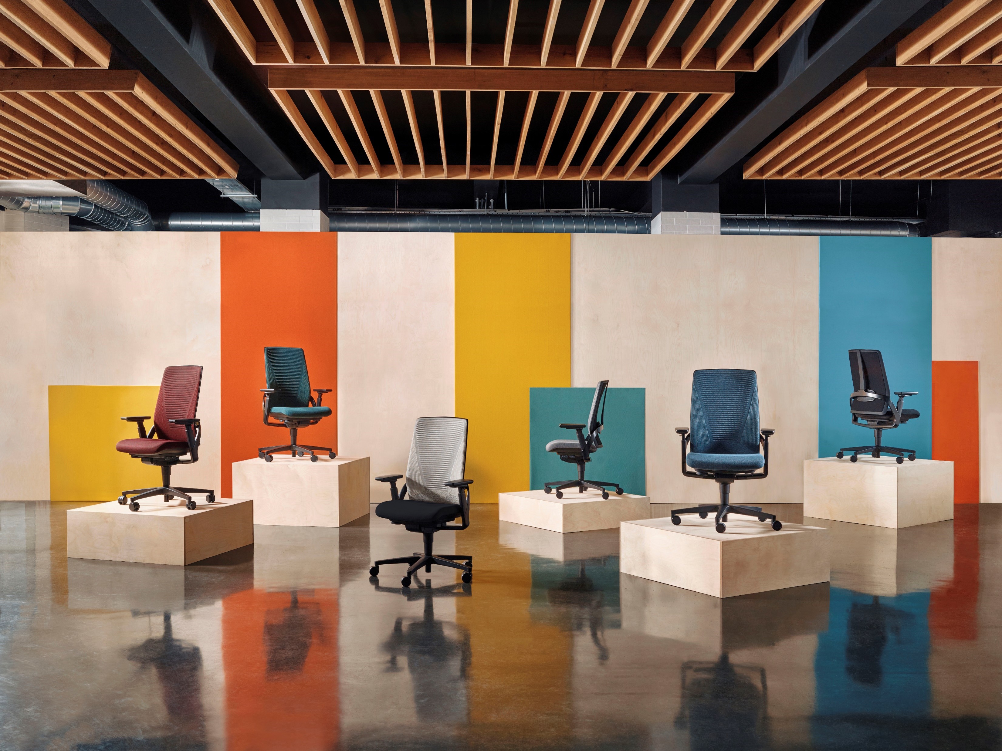 colourful office chairs on podiums in a showroom